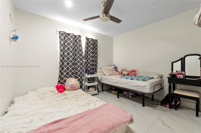 bedroom featuring marble finish floor and ceiling fan
