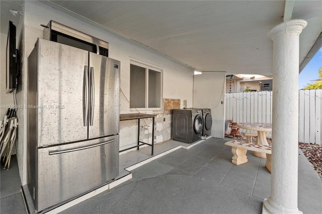 view of patio with fence and washer and dryer