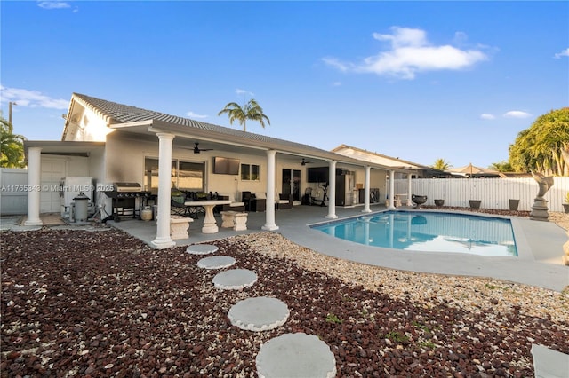view of swimming pool with a fenced backyard, area for grilling, a fenced in pool, a ceiling fan, and a patio area