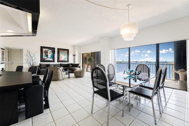 1800 NE 114th St Unit Ph06, Miami, FL 33181 - dining room with a notable chandelier, light tile patterned floors, and a textured ceiling