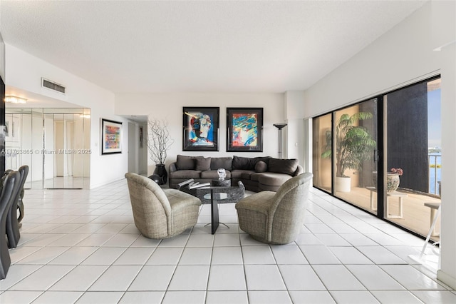 1800 NE 114th St Unit Ph06, Miami, FL 33181 - living area featuring light tile patterned floors, visible vents, and a textured ceiling