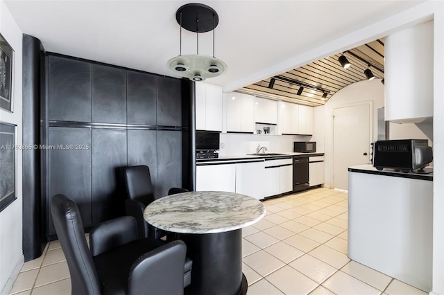 1800 NE 114th St Unit Ph06, Miami, FL 33181 - kitchen featuring white cabinetry, light tile patterned flooring, black microwave, and a sink