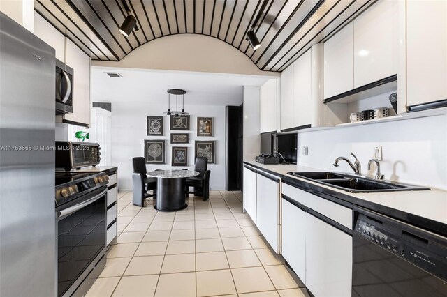1800 NE 114th St Unit Ph06, Miami, FL 33181 - kitchen with visible vents, a sink, hanging light fixtures, white cabinets, and appliances with stainless steel finishes