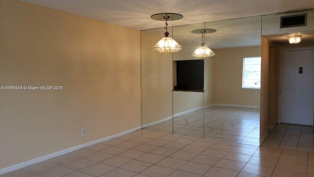 4394 NW 9th Ave Unit 20-3H, Deerfield Beach, FL 33064 - unfurnished room with visible vents, baseboards, a textured ceiling, and light tile patterned flooring