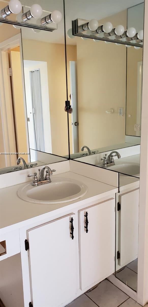 4394 NW 9th Ave Unit 20-3H, Deerfield Beach, FL 33064 - bathroom featuring tile patterned floors and vanity