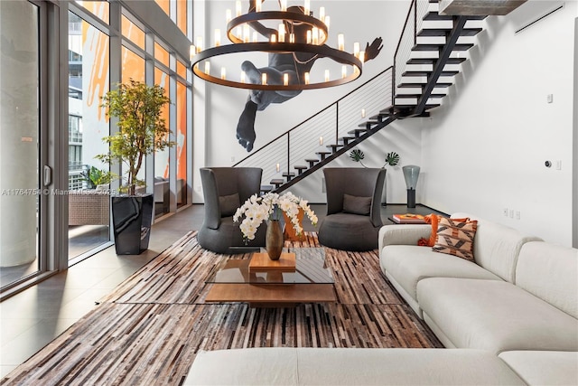 living area with tile patterned flooring, an inviting chandelier, and stairway