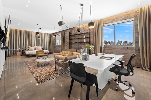 dining space with a city view and finished concrete floors