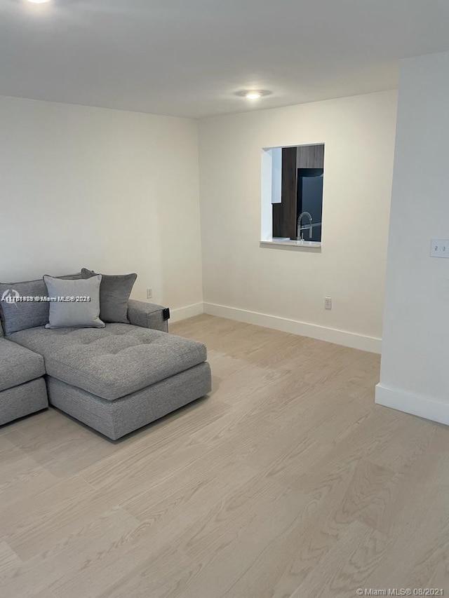 living room featuring baseboards and light wood finished floors
