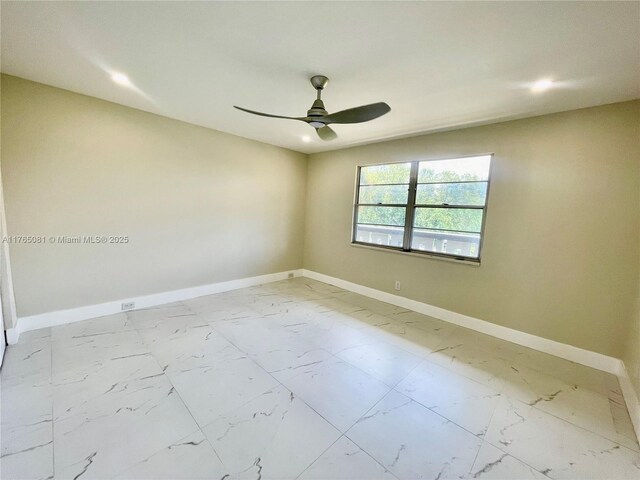 3005 Portofino Isle Unit F3, Coconut Creek, FL 33066 - spare room with marble look tile flooring, baseboards, and ceiling fan