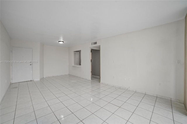 unfurnished room featuring light tile patterned floors and visible vents