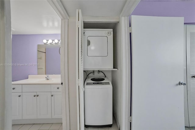 laundry room with a sink, stacked washer and clothes dryer, and laundry area