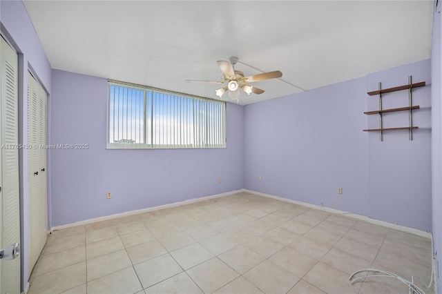 unfurnished bedroom with baseboards and a ceiling fan