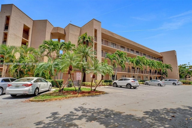 view of property featuring uncovered parking