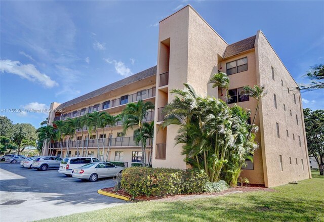 view of property featuring uncovered parking