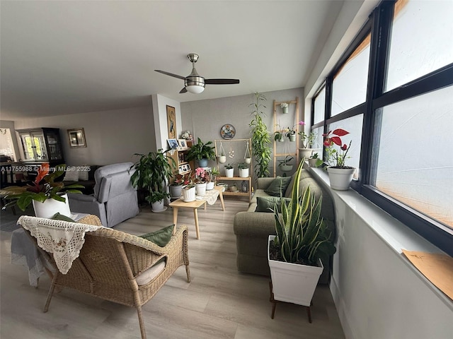 sunroom / solarium featuring ceiling fan