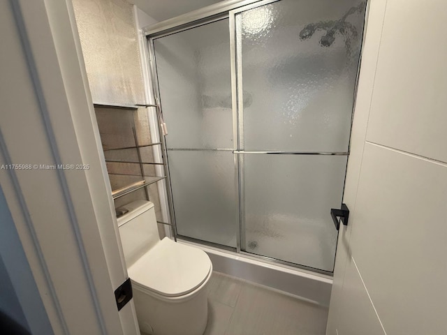 full bath with toilet and a shower stall