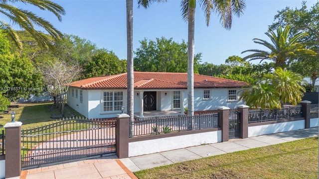 6961 SW 152nd St, Palmetto Bay, FL 33157 - mediterranean / spanish house featuring a tiled roof, stucco siding, and a gate