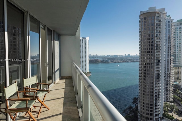 balcony featuring a view of city and a water view