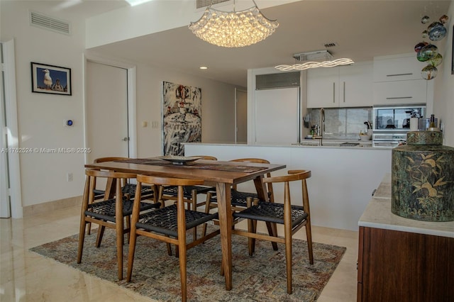 dining area with visible vents and an inviting chandelier