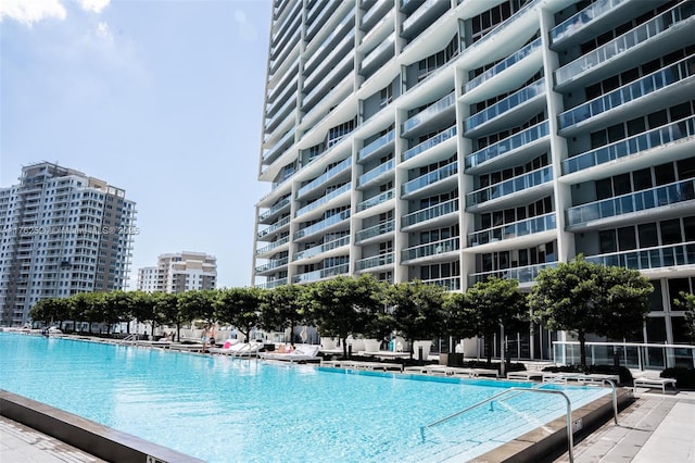 view of swimming pool featuring a city view