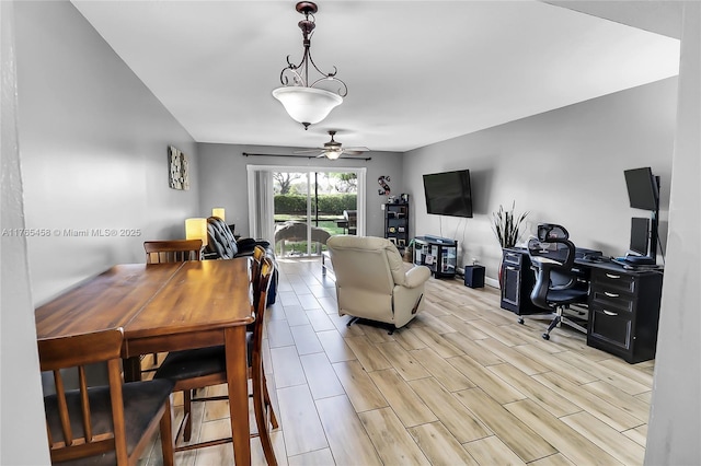 living room featuring baseboards, ceiling fan, and wood tiled floor