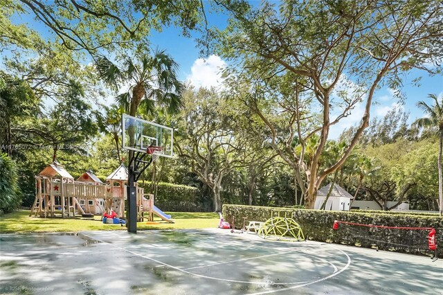 4550 Sunset Dr, Coral Gables, FL 33143 - view of basketball court with a playground, basketball court, a yard, and view of wooded area
