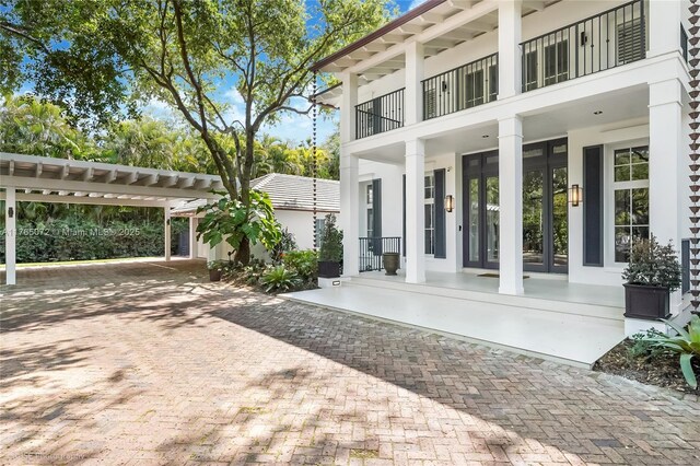 4550 Sunset Dr, Coral Gables, FL 33143 - view of patio featuring a balcony and french doors