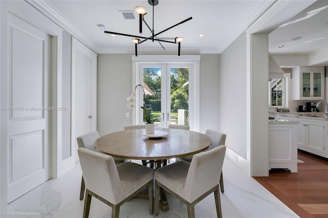 4550 Sunset Dr, Coral Gables, FL 33143 - dining room featuring crown molding, a chandelier, and light marble finish floors