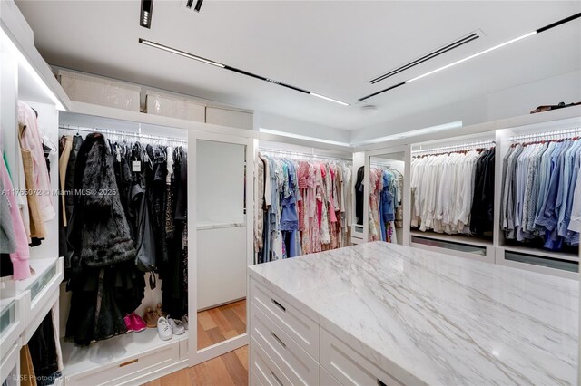 4550 Sunset Dr, Coral Gables, FL 33143 - walk in closet featuring light wood-style flooring