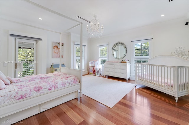 4550 Sunset Dr, Coral Gables, FL 33143 - bedroom with a chandelier, wood finished floors, ornamental molding, and access to exterior