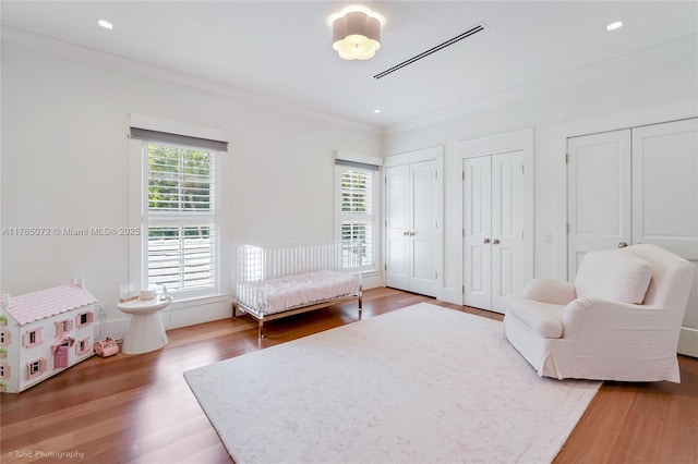 4550 Sunset Dr, Coral Gables, FL 33143 - bedroom featuring multiple windows, wood finished floors, and ornamental molding