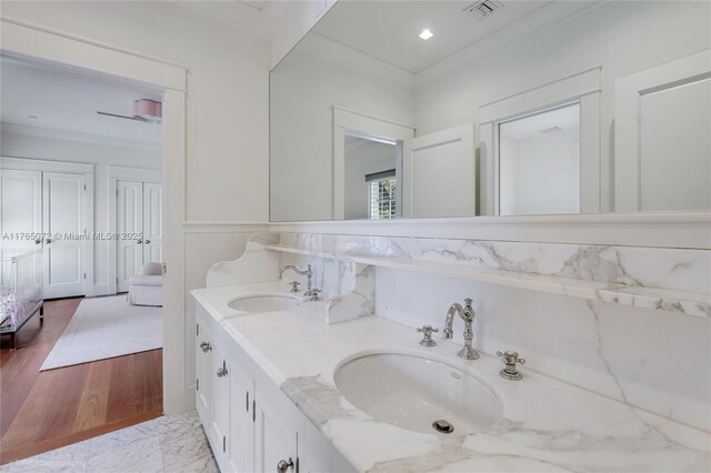 4550 Sunset Dr, Coral Gables, FL 33143 - full bathroom featuring ornamental molding, double vanity, wainscoting, and wood finished floors