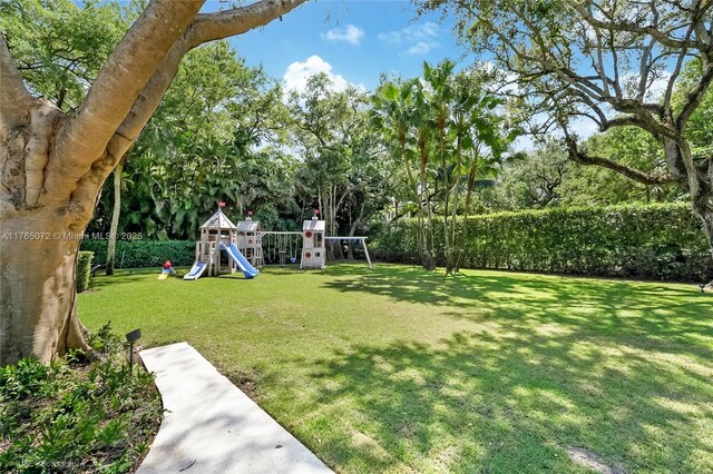 4550 Sunset Dr, Coral Gables, FL 33143 - view of yard featuring a playground and view of wooded area