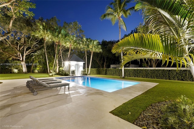 4550 Sunset Dr, Coral Gables, FL 33143 - pool at night featuring a patio