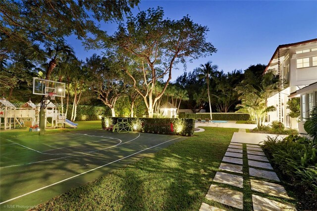 4550 Sunset Dr, Coral Gables, FL 33143 - view of basketball court featuring a playground, a lawn, and basketball hoop