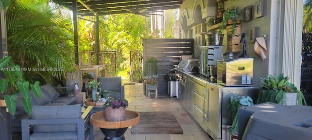 949 Harbor Vw N, Hollywood, FL 33019 - view of patio / terrace with exterior kitchen, a garage, and an outdoor hangout area