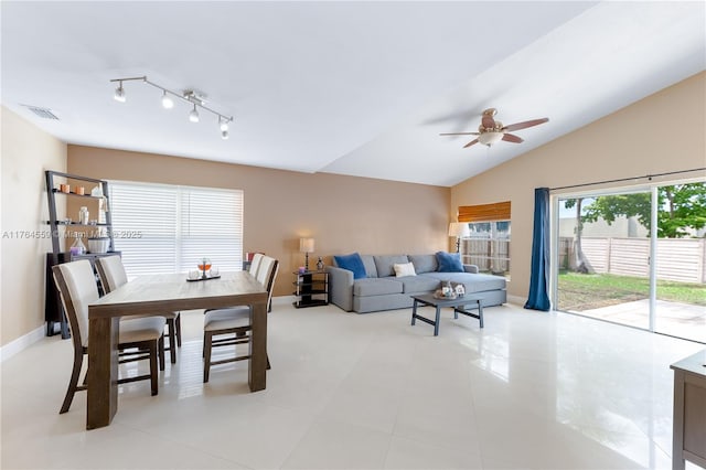 living room with vaulted ceiling, visible vents, baseboards, and a ceiling fan