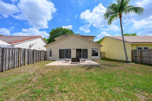 19852 NW 88th Ave, Hialeah, FL 33018 - rear view of house featuring a fenced backyard, a patio area, and stucco siding