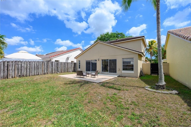 back of property featuring a fenced backyard, a patio, stucco siding, and a lawn