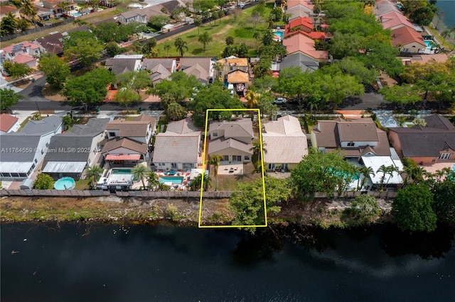 bird's eye view featuring a water view and a residential view