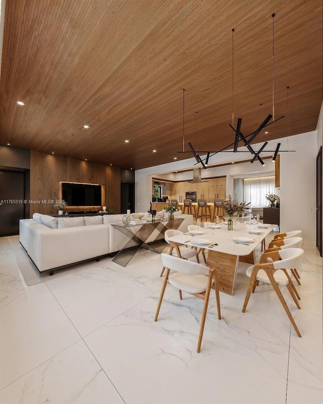 unfurnished dining area featuring recessed lighting, marble finish floor, and wood ceiling