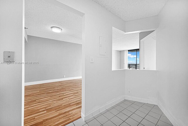 3300 NE 191st St Unit Lp03, Aventura, FL 33180 - unfurnished room featuring a textured ceiling, baseboards, and tile patterned flooring