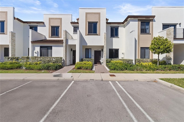 view of property with uncovered parking
