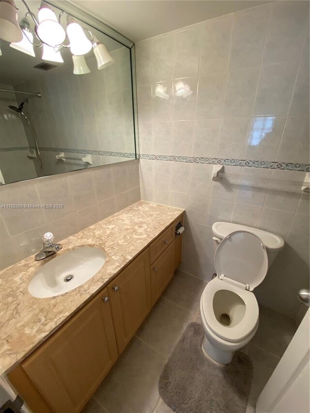 3725 S Ocean Dr Unit 607, Hollywood, FL 33019 - full bathroom with vanity, tile walls, tile patterned flooring, toilet, and a shower