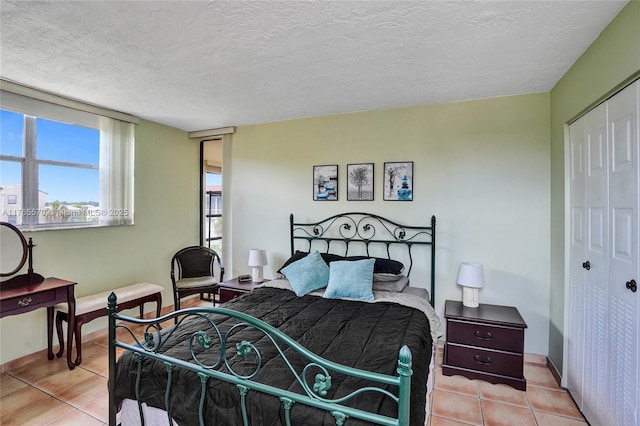 2811 Somerset Dr Unit 405, Lauderdale Lakes, FL 33311 - bedroom with a closet, a textured ceiling, and tile patterned flooring