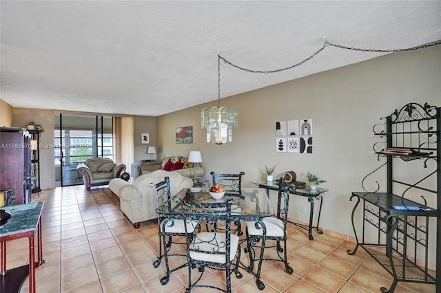 2811 Somerset Dr Unit 405, Lauderdale Lakes, FL 33311 - tiled dining room featuring a textured ceiling and a chandelier