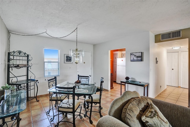 2811 Somerset Dr Unit 405, Lauderdale Lakes, FL 33311 - dining space with light tile patterned floors, visible vents, and a textured ceiling