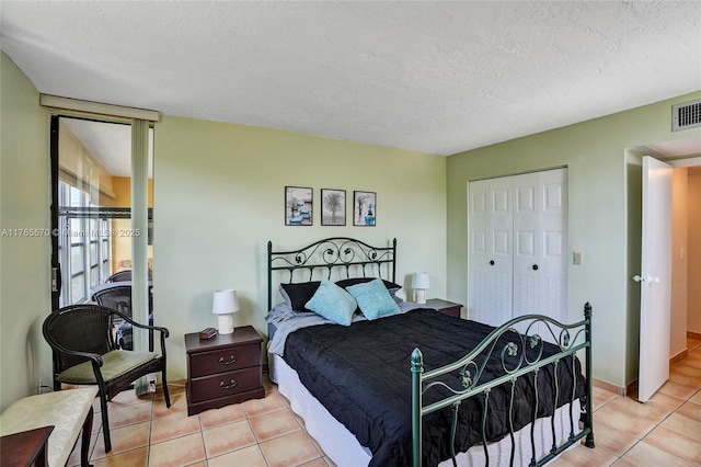 2811 Somerset Dr Unit 405, Lauderdale Lakes, FL 33311 - bedroom featuring light tile patterned floors, a closet, and a textured ceiling