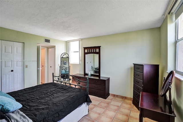 2811 Somerset Dr Unit 405, Lauderdale Lakes, FL 33311 - bedroom with light tile patterned flooring, visible vents, a textured ceiling, and a closet