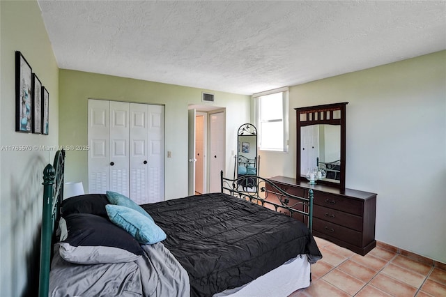 2811 Somerset Dr Unit 405, Lauderdale Lakes, FL 33311 - bedroom featuring a closet, visible vents, a textured ceiling, and light tile patterned flooring